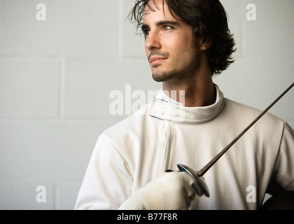 Portrait of fencer holding fencing foil Stock Photo