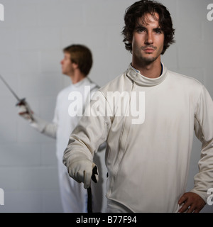 Portrait of fencers holding fencing foils Stock Photo