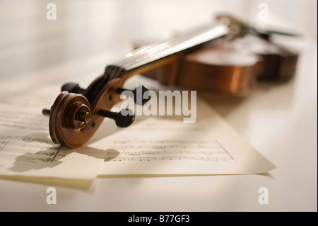 Violin laying on sheet music Stock Photo
