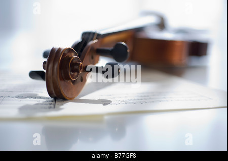 Violin laying on sheet music Stock Photo