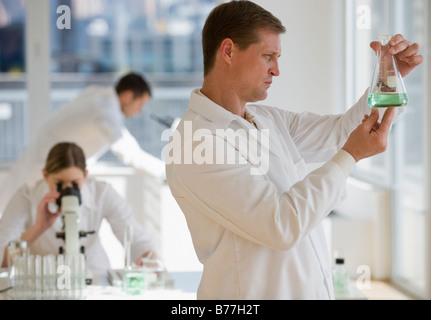 Scientist examining liquid pharmaceutical laboratory Stock Photo