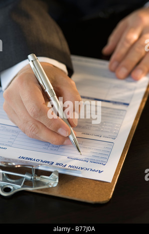Man filling out employment application Stock Photo