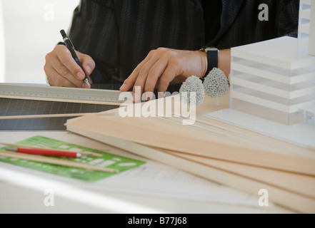 Architect working on building model Stock Photo