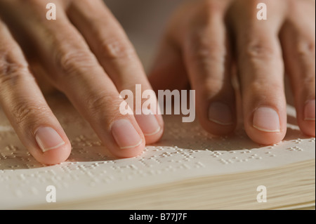 Close up of hand reading braille