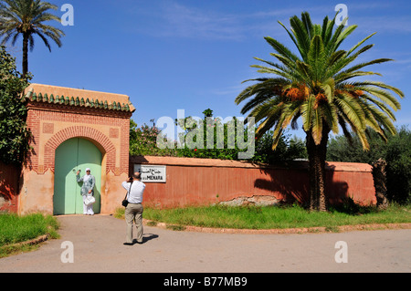 Moroccan couple taking photos at the entrance of the Saadier-Palais in the Menara Gardens, Marrakech, Morocco, Africa Stock Photo