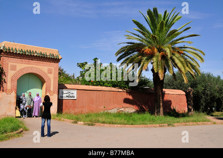 Moroccan family taking photos at the entrance of the Saadier-Palais in the Menara Gardens, Marrakech, Morocco, Africa Stock Photo