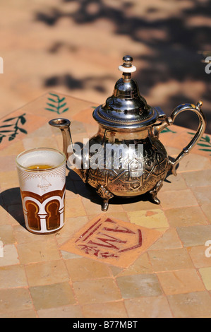 Silver teapot and tea glass with peppermint tea, Menara Gardens, Marrakech, Morocco, Africa Stock Photo