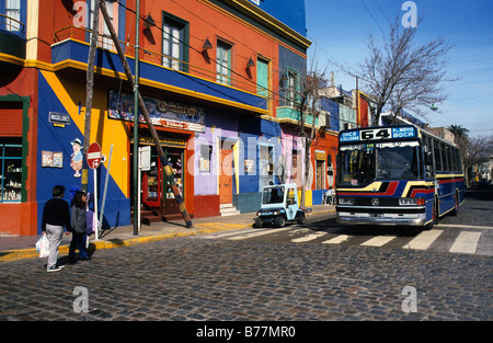 Bus in front of a colourful house facade in the dockland area La Boca, Buenos Aires, Argentina, South America Stock Photo