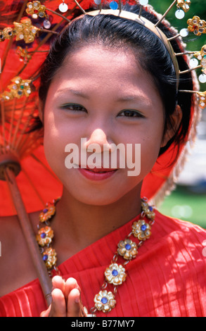 Young Thai girl in traditional dress in front of the Hindu-Buddist Monastery Wat Arun in Bangkok, Thailand, Asia Stock Photo