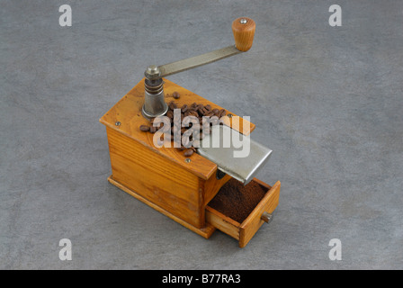 Antique coffee mill with grinding drawer full of freshly ground coffee Stock Photo