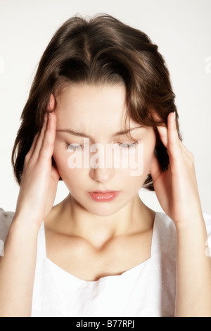 Young woman massaging her temples Stock Photo - Alamy