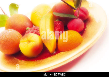 Marzipan fruits on plate Stock Photo