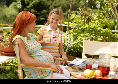 Girl and pregnant woman Stock Photo