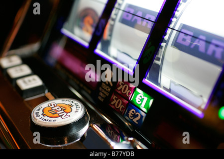 casino slot machine one euro jetton coin easy spin money betting gaming electron roulette wheel shop legal addiction habit check Stock Photo