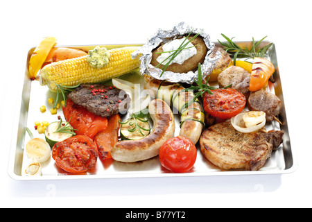 Grilled meat, sausage and vegetables on tray Stock Photo