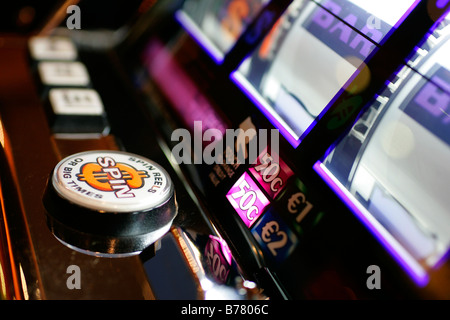 casino slot machine one euro jetton coin easy spin money betting gaming electron roulette wheel shop legal addiction habit check Stock Photo