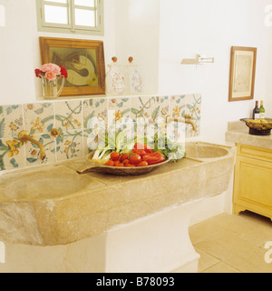 Double stone basin with patterned tiles in kitchen of Mallorcan Finca restoration Stock Photo