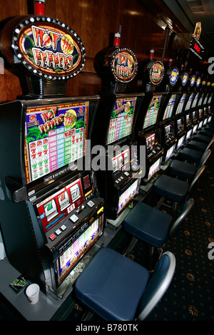 casino slot machine gamblers woman female girl boy man people betting gaming one euro jetton coin easy spin money electron shop Stock Photo