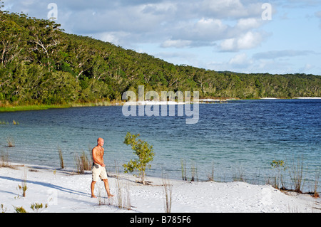 Young man walks near Lake McKenzie, Fraser Island, Queensland, Australia Stock Photo