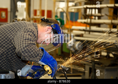 Machinist grinding metal in a factory Horizontal with room for text Authentic and accurate content depiction Stock Photo