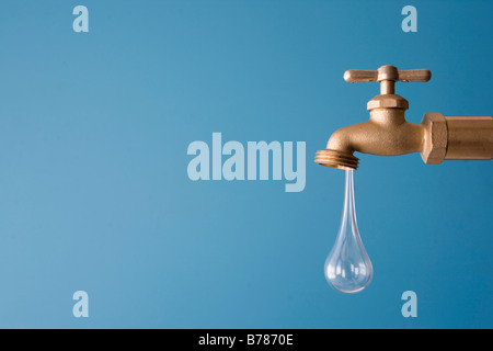 giant drop of water drips from faucet Stock Photo