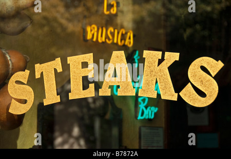 sign on glass window for steaks in bold gold lettering in fort worth texas Stock Photo