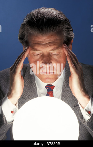 Businessman Fortune Teller and crystal ball Stock Photo