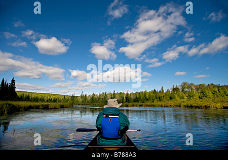 Canoeing to a new fishing spot in the Boundary Waters Canoe Area Wilderness in the Superior National Forest in Minnesota. Stock Photo