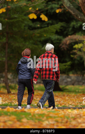 Senior couple walking in park in autumn Victoria British Columbia Canada Stock Photo