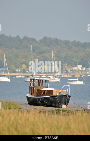 Small boat at low tide on the Medway river Rochester Kent United Kingdom