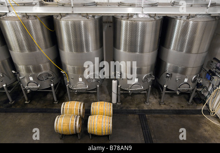 STAINLESS STEEL WINE TANKS and OAK BARRELS are used to age wine at JOULLIAN VINEYARDS CARMEL VALLEY CALIFORNIA Stock Photo