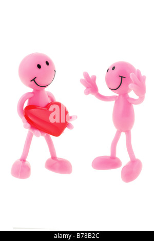 One smiley holding love heart giving to another Stock Photo