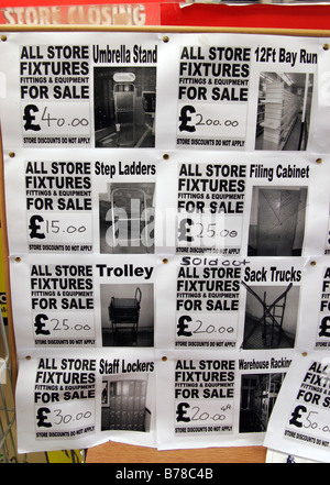 Stock clearance notices in a Woolworths Store in Finchley Road, London Stock Photo