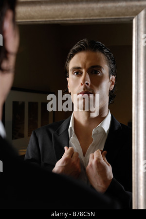 Young man looking at a mirror Stock Photo