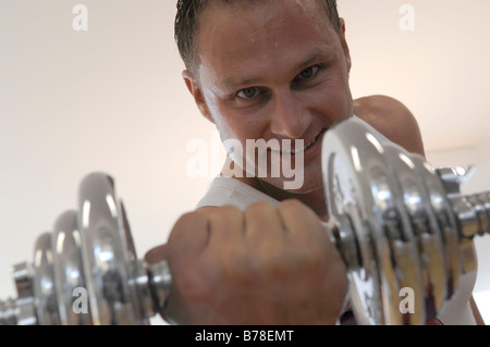 Man Lifting a Dumbbell, portrait, close-up Stock Photo