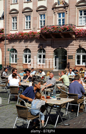 Bar café restaurant terrace, guests, on the Marktplatz Square in sommer, in the back the facade of the town hall, historic cent Stock Photo