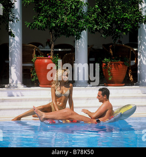 Couple relax in swimming pool. Stock Photo