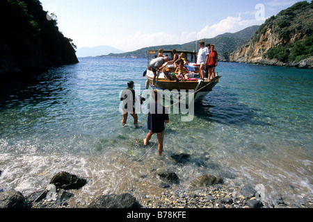 Boat on a beach in a bay between Dalyan and Sarigerme, Mugla Province, Mediterranean, Turkey Stock Photo