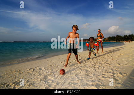 Children playing football on the beach of Laguna Resort, The Maldives, Indian Ocean