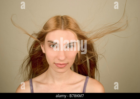 Young woman's long red hair blowing in the wind.  Model Released. Stock Photo
