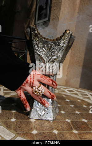Hand with henna-painting holding incense holder, Dubai, United Arab Emirates, Middle East Stock Photo