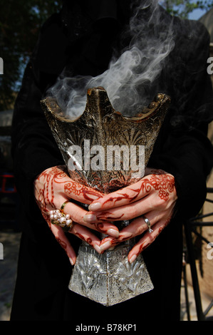 Hands of a woman with henna-painting holding incense holder, Dubai, United Arab Emirates, Middle East Stock Photo