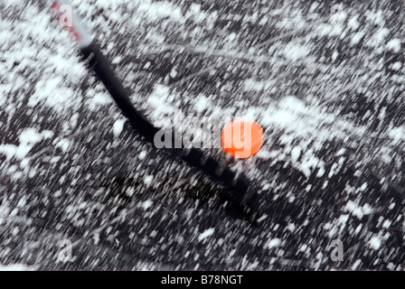 Ice hockey stick and puck on frozen lake, elevated view Stock Photo