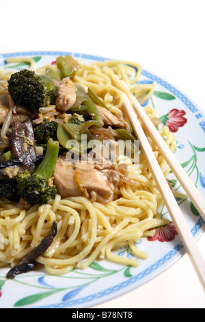 Chicken chow mein (canonese noodles) on a plate with chopsticks Stock Photo