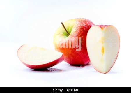 Sliced apple pieces and an apple, close-up Stock Photo