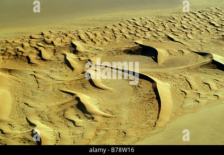 Aerial view showing crescent-shaped sand dunes Stock Photo