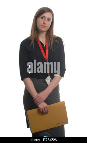 young female office worker with an id tag holding a folder looking bored Stock Photo