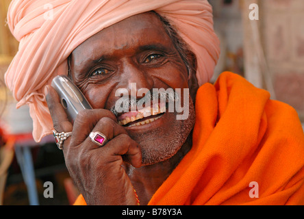 Man using a mobile phone, Ram Devra pilgrims festival, Ramdevra, Pokhran, Rajasthan, North India, Asia Stock Photo