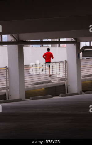 A man running in a parking garage in Reno in Nevada Stock Photo