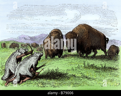 Native Americans in wolf skins stalking buffalo. Hand-colored woodcut Stock Photo